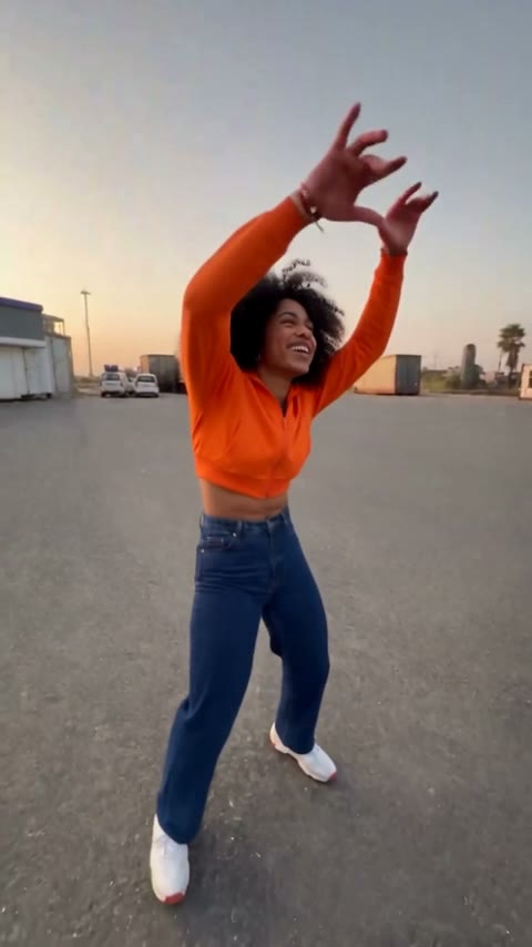 Gas station dance trend shot 1: freestyle dance on an empty lot at dusk