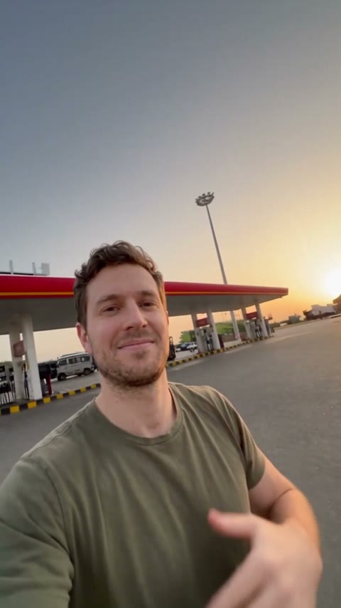 Gas station dance trend shot 2: handheld selfie with a gas station behind